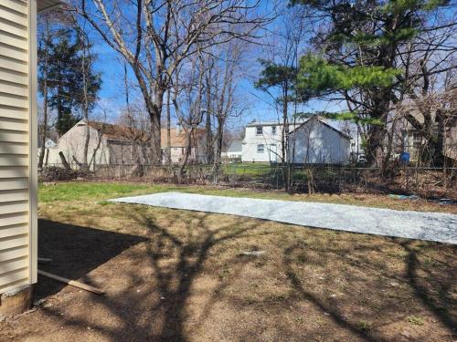 a driveway leading into a yard with a house at Spacious home away from home in Bloomfield