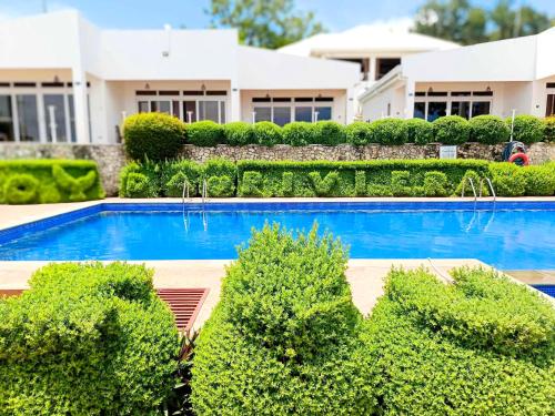 a swimming pool in front of a house at The Gabayan Riviera in Siquijor