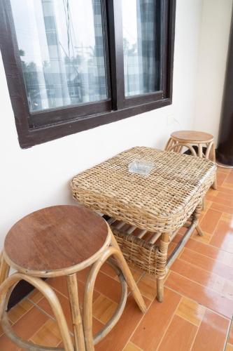 a table and two stools and a table and chairs at Shelves Siargao in General Luna