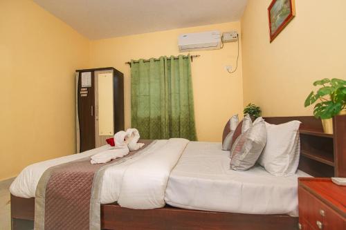 a bedroom with a bed with towels on it at Margaritas Residency in Benaulim