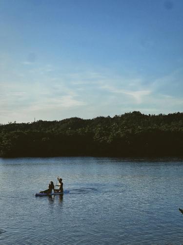 two people are on a raft in a lake at Shelves Siargao in General Luna