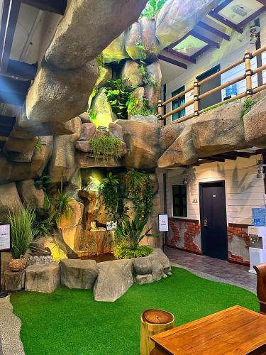 an indoor aquarium with a large rock wall at D'Garden Hotel Kuala Lumpur in Kuala Lumpur