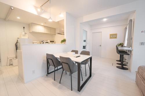 a dining room and kitchen with a table and chairs at Miyako Beach Resort in Hirara