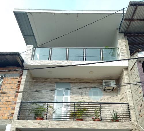 a building with a balcony with potted plants on it at Salomeapart2 in Tarapoto