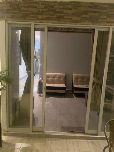 an open glass door with a couch in a room at Salomeapart2 in Tarapoto