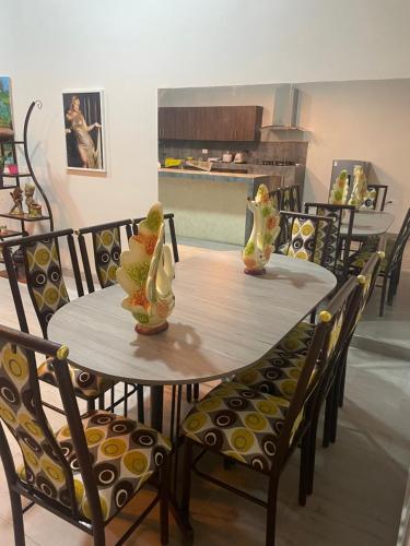 a dining room table with chairs and vases on it at Salomeapart2 in Tarapoto