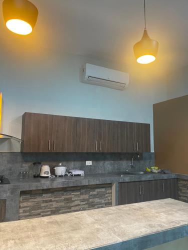 a kitchen with wooden cabinets and a counter top at Salomeapart2 in Tarapoto