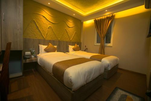 a hotel room with two beds in a room at Divya Boutique Inn in Kathmandu
