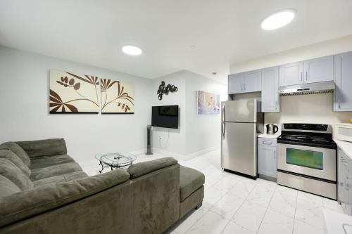 a living room with a couch and a kitchen at Basement Suite In Vancouver in Vancouver
