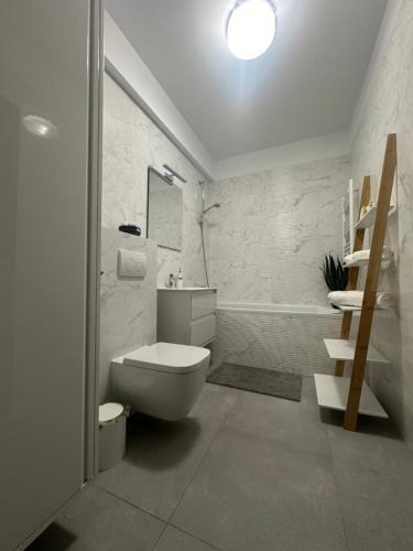 a bathroom with a toilet and a staircase in it at Love Room Secret-private jacuzzi spa & cinéma Bucuresti in Voluntari