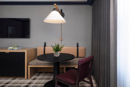 a room with a table and chairs and a lamp at Omni Interlocken Hotel in Broomfield