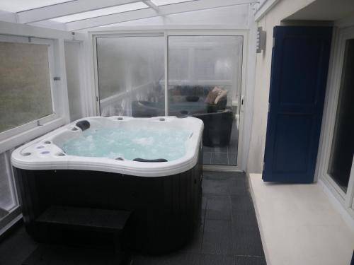 bañera grande en una habitación con ventana en Mouli Del Riu en Saint-Pierre-dels-Forcats