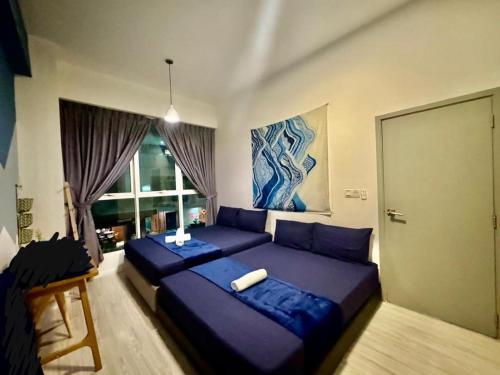 a bedroom with two beds and a large window at SA Sutera Avenue Homestay Opposite Imago KK in Kota Kinabalu