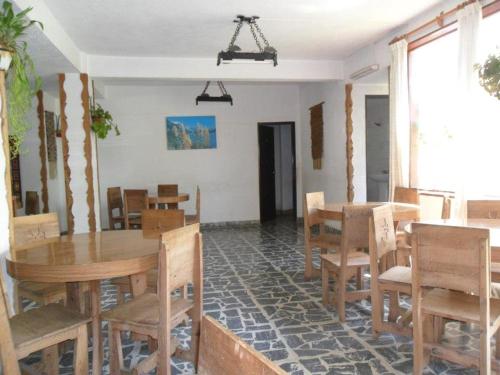 comedor con mesas y sillas de madera en Hotel Panoramico Bariloche en San Carlos de Bariloche