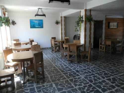 a dining room with wooden tables and chairs at Hotel Panoramico Bariloche in San Carlos de Bariloche