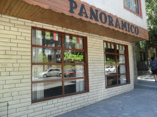 a store front with reflections of cars in the windows at Hotel Panoramico Bariloche in San Carlos de Bariloche
