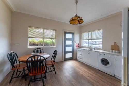 a kitchen and dining room with a table and chairs at Cosy and Comfortable Unit with Parking & Wifi in Devonport