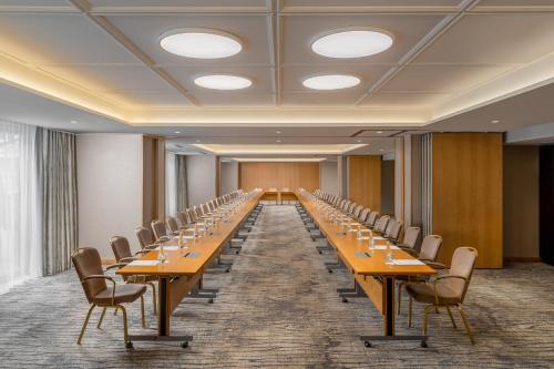 a large conference room with long tables and chairs at InterContinental Athenee Palace Bucharest by IHG in Bucharest