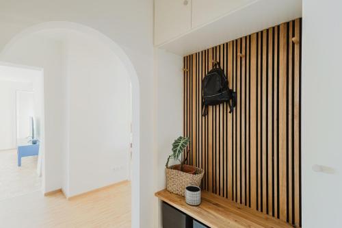 a room with a wooden wall with a plant on a bench at FerienWohnenSieglinde in Weiden