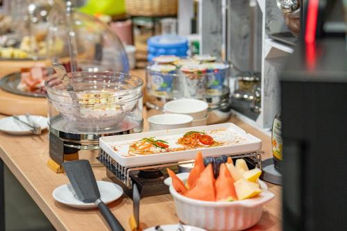 a counter with a plate of food and a bowl of fruit at B&B Bellagio Davos in Davos