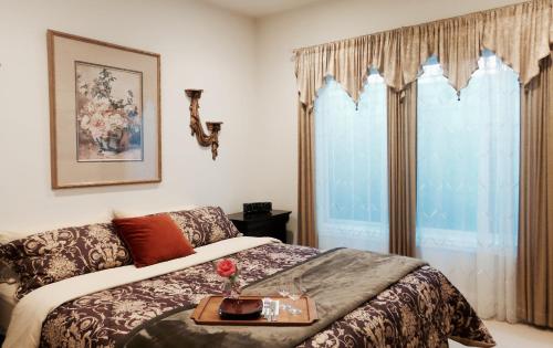 a bedroom with a bed with a tray on it at Little Paradise with Sauna Garden near Downtown in Saratoga