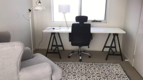 a room with a desk and a chair and a desk at Kellyvile Delight 5BrHouseParkingShopping Center in Kellyville