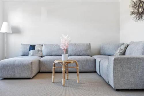 a living room with a couch and a table at Kellyvile Delight 5BrHouseParkingShopping Center in Kellyville