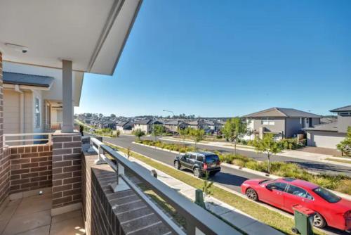 two cars parked on a street in a house at Kellyvile Delight 5BrHouseParkingShopping Center in Kellyville