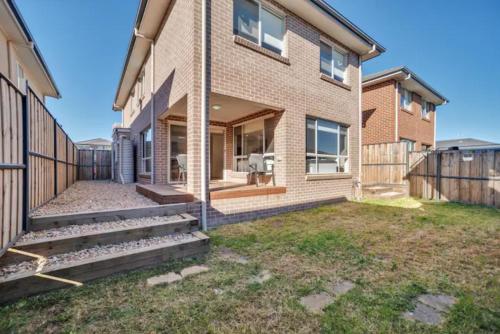 a brick house with steps leading to the front yard at Kellyvile Delight 5BrHouseParkingShopping Center in Kellyville