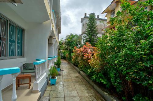 an alley in a building with plants at Candolim Beach Vaddo 15 in Calangute