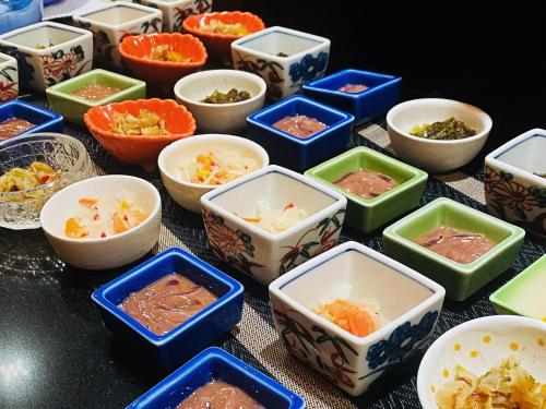 a group of bowls of food on a table at Hotel Kusakabe Armeria in Gero