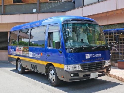 a blue bus parked in front of a building at Hotel Kusakabe Armeria in Gero