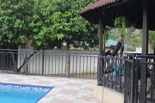 a black fence next to a swimming pool at NARU Extremo in Utica