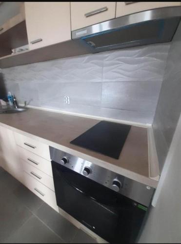 a kitchen with a stove and a counter top at Apartments Josif in Gevgelija