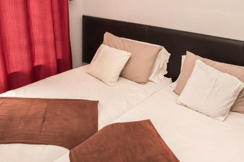 Postel nebo postele na pokoji v ubytování Mauya Guesthouse