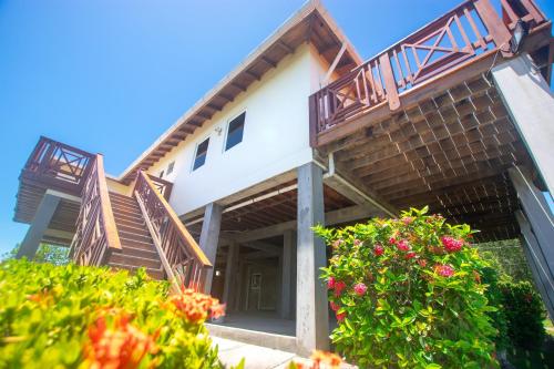 a house with balconies on the side of it at Coco View Canal lot 18 private home home in Roatan