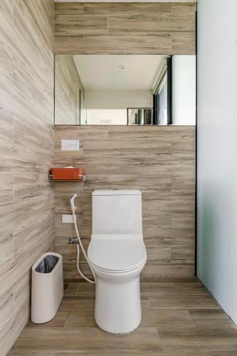 a bathroom with a white toilet and a mirror at Ningxia Ocean in Yilan City