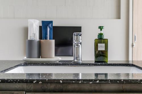 a kitchen counter with a sink and a bottle of soap at Ningxia Ocean in Yilan City