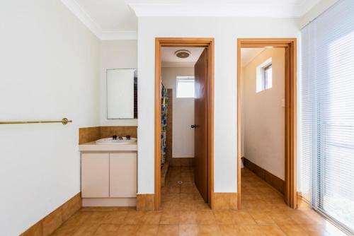 a bathroom with a sink and a toilet at Ninettas Views - Great coastal location in Guilderton