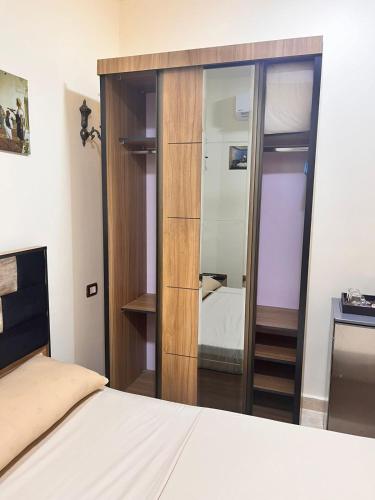 a bedroom with a large mirror and a bed at Reef House in Marsa Alam City