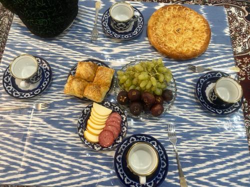 a blue and white table with a plate of food at Rustam Family guest house Bukhara Old city in Bukhara