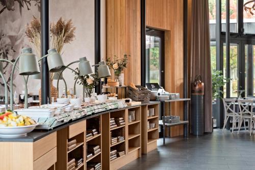 a room with a counter with food on it at Best Western Valhall Park Hotell in Ängelholm