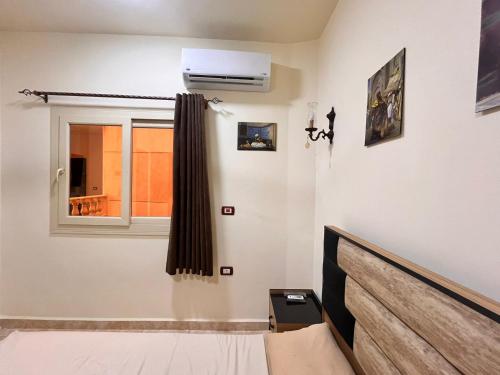 a bedroom with a bed and a window at Reef House in Marsa Alam City