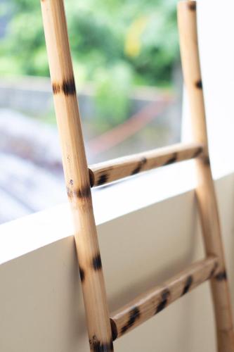 a wooden chair in front of a window at Shelves Siargao in General Luna