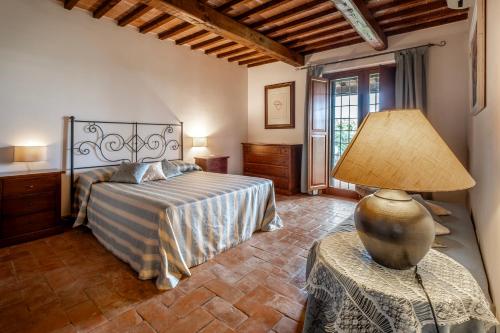 En eller flere senge i et værelse på Agriturismo Poggio delle Conche