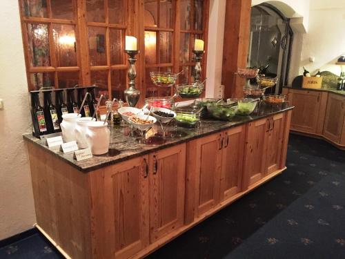 a kitchen counter with a bunch of food on it at Hotel Karl Schranz in Sankt Anton am Arlberg