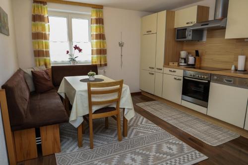 a small kitchen and dining room with a table and chairs at Apartments Gabl in Schönwies