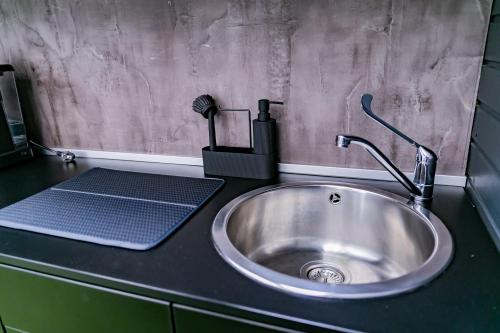 a kitchen sink with a faucet on a counter at Motel1- A megfizethető luxus! in Dunaújváros