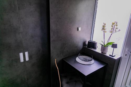 a room with a small table and a window at Motel1- A megfizethető luxus! in Dunaújváros