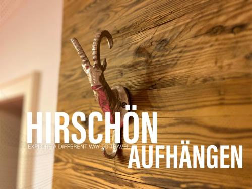 a sign with a pair of scissors hanging on a wall at 80 m2, für bis 6 Personen mit tollem Skigebiet, zentral und doch ruhig in Waidring